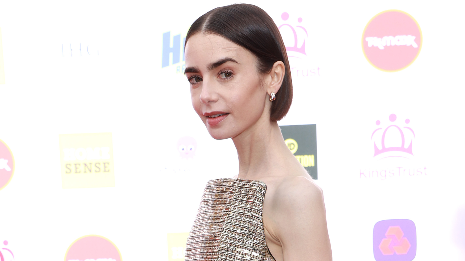 Lily Collins wore a strapless gold dress from Carolina Herrera to the King&rsquo;s Trust Celebration in London